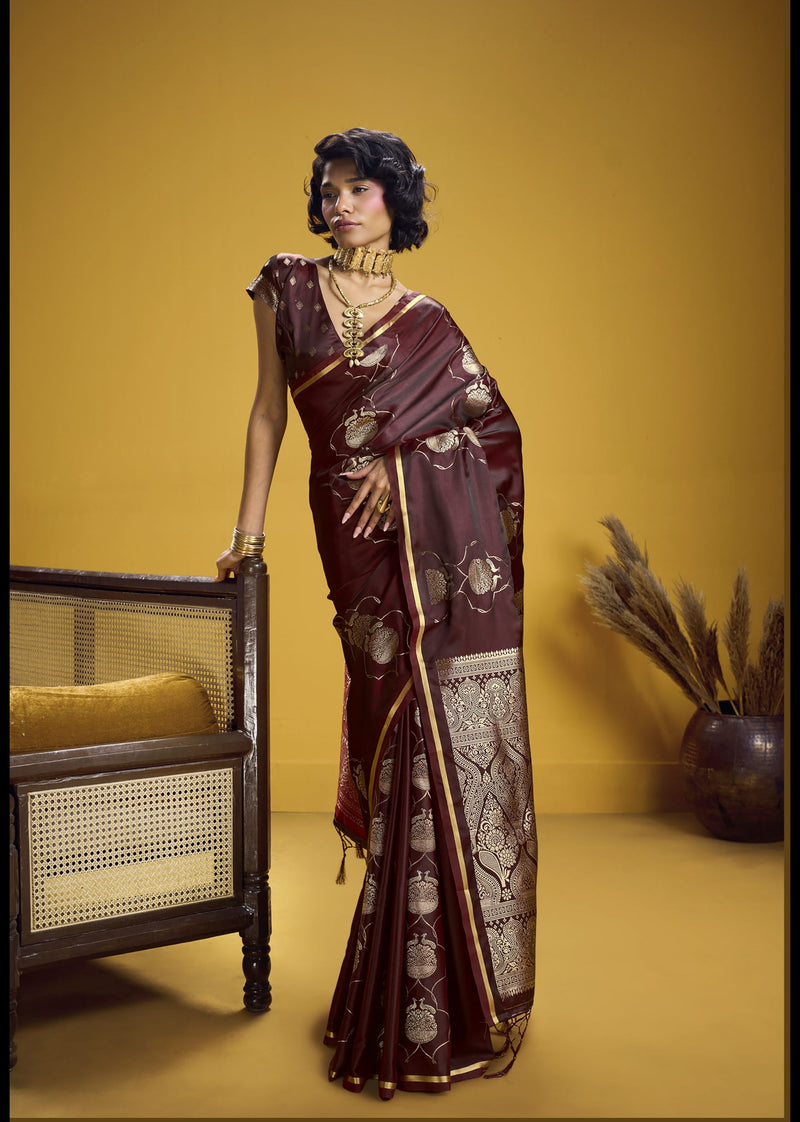 Maroon silk saree with detailed gold motifs and traditional zari work.