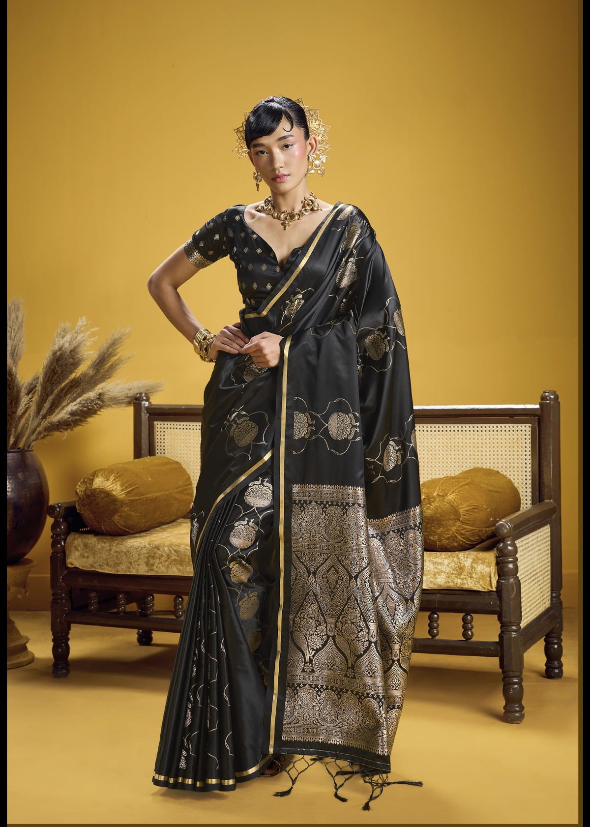 Black silk saree with ornate gold embroidery and floral zari detailing