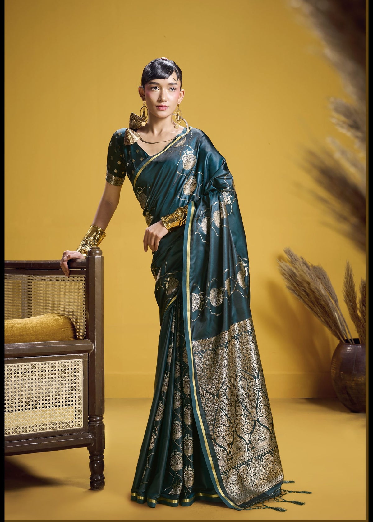 Dark green silk saree with heavy gold threadwork and traditional pallu design