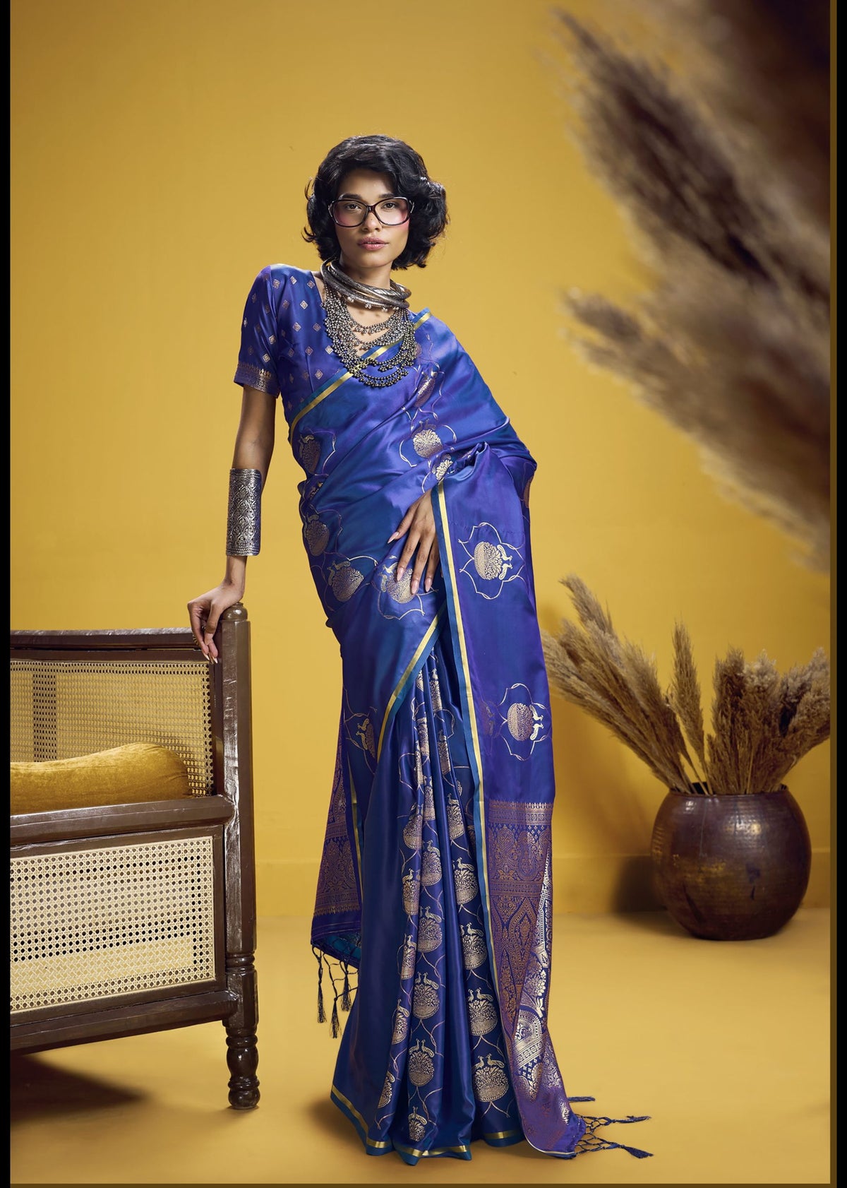 Royal blue silk saree with gold motifs and contrasting green‑gold border