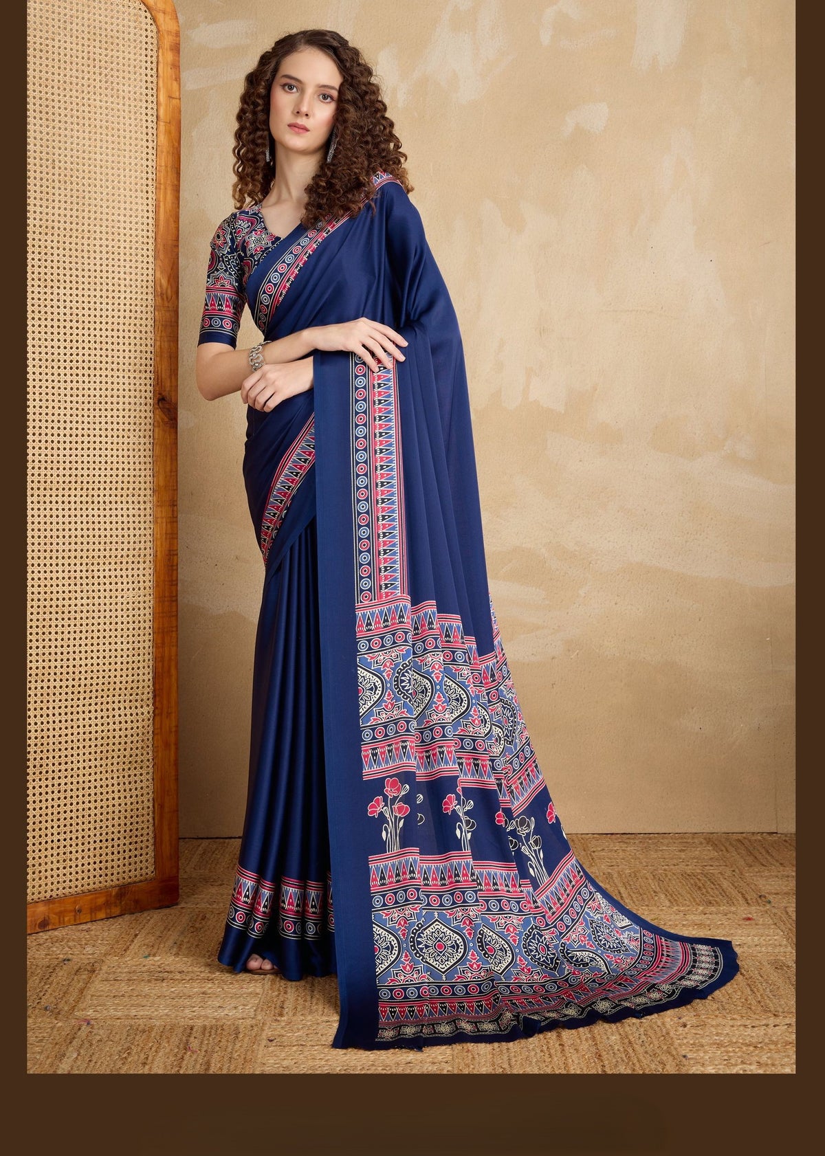 Navy blue pure satin saree featuring intricate Ajrakh patterns in red, white and green; bold border and pallu.