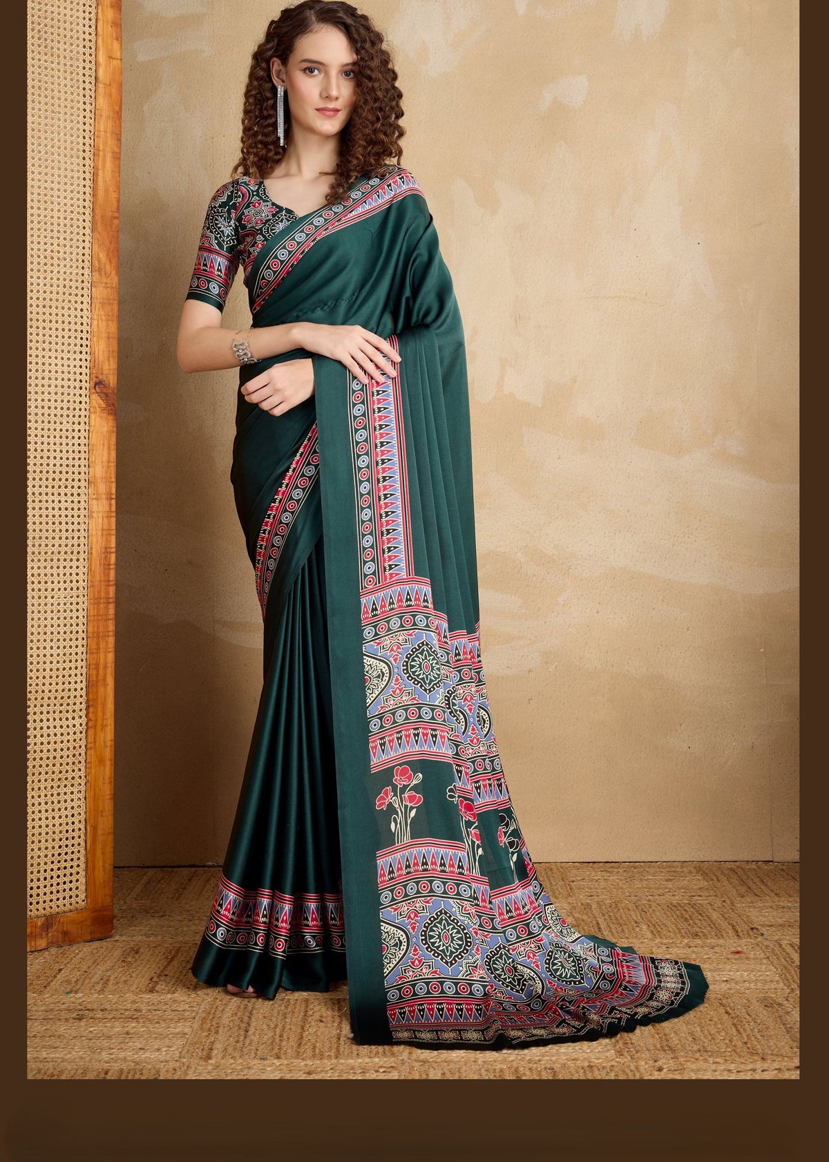Dark green pure satin saree with multicolour Ajrakh motifs in red, pink and white; floral pallu and geometric border.