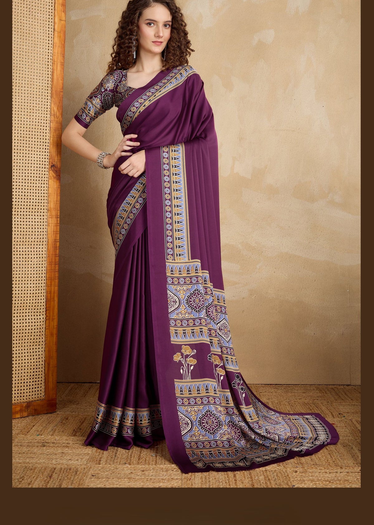Rich purple pure satin saree with gold, blue and white Ajrakh designs; ornate pallu and symmetrical border.