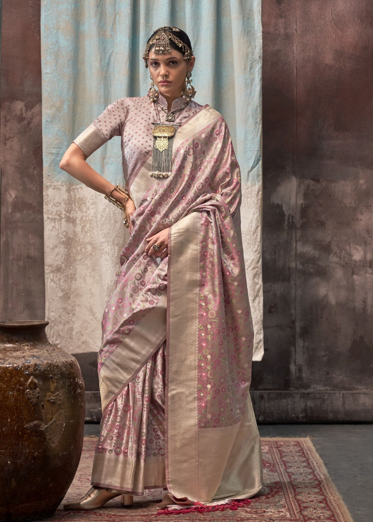 Pink handloom silk saree with fine floral weaving and a wide light‑gold zari border, complemented by a dotted pink blouse.