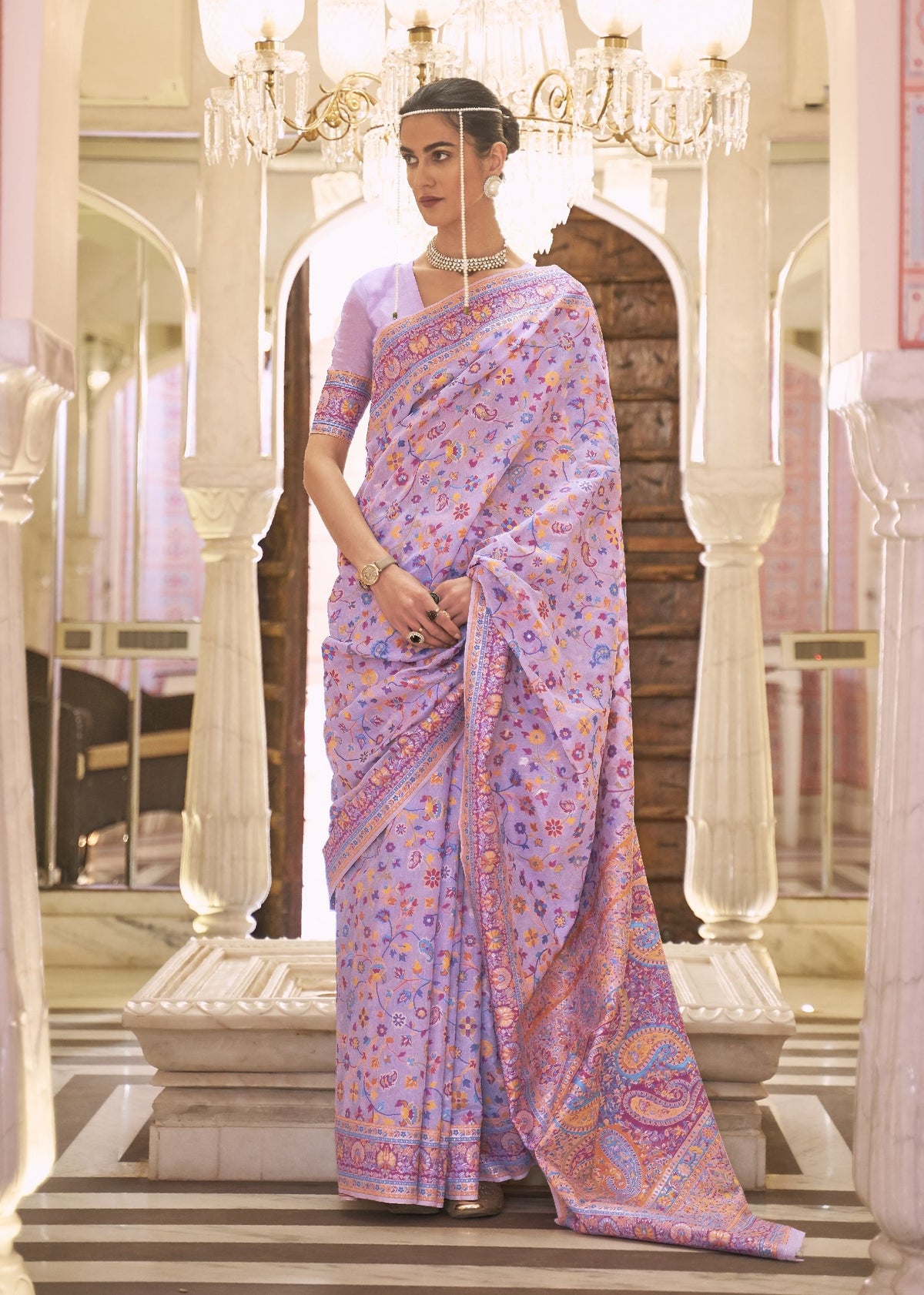 Lavender Kashmiri silk saree with vibrant floral detailing and rich border, worn for receptions and traditional indian bridal fashion.