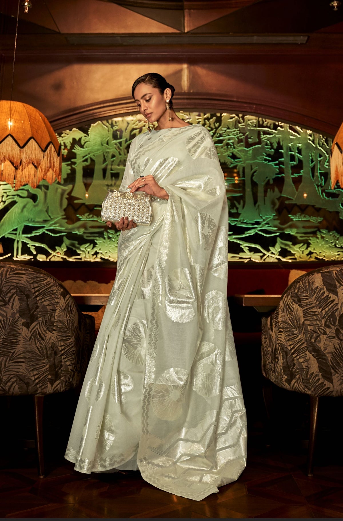 Off-white Mint silk saree with silver circular and geometric motifs—refined festive look for weddings and upscale gatherings