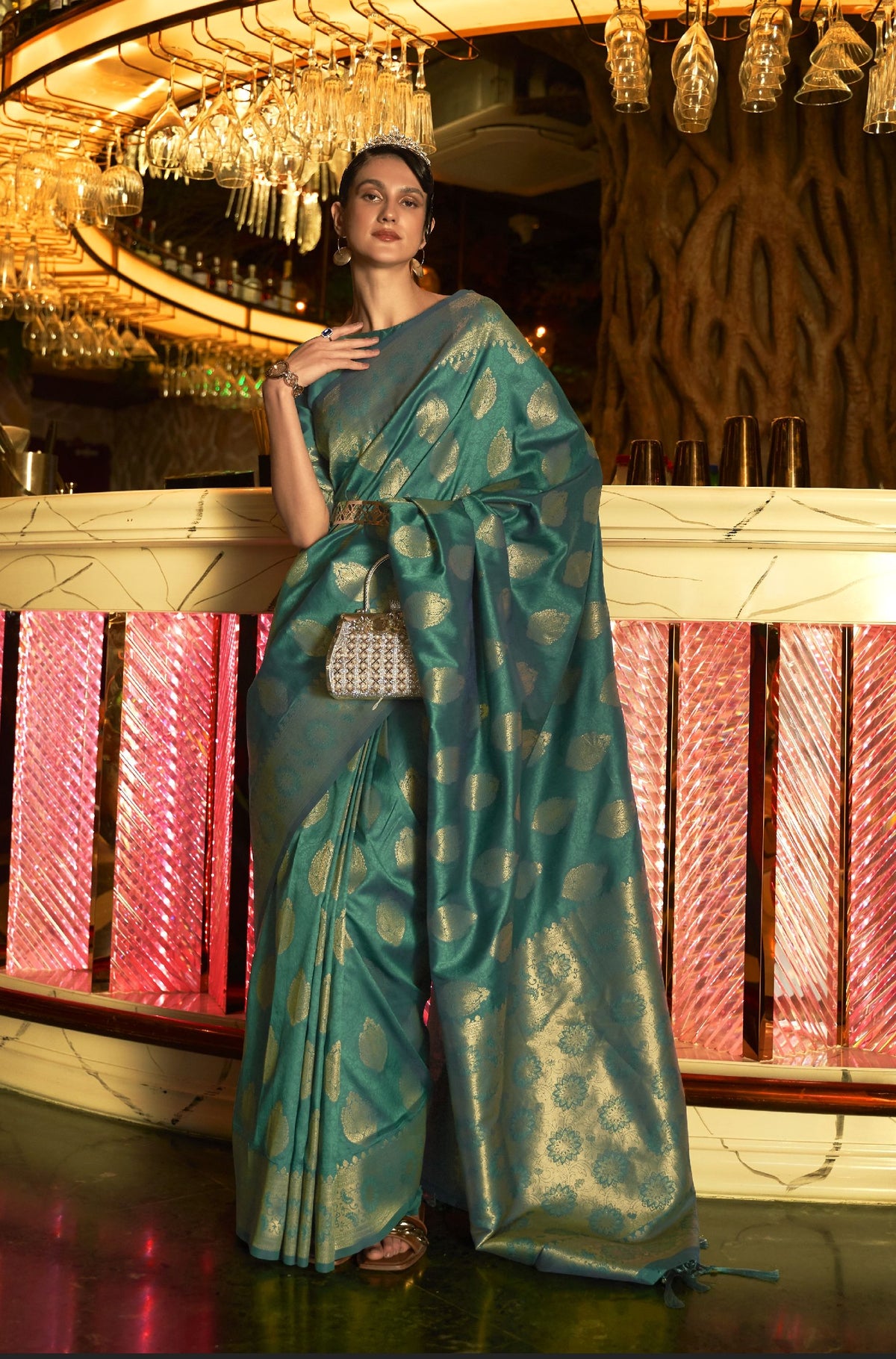 Teal handloom silk saree with golden motifs—bold festive elegance for Navratri and evening occasions