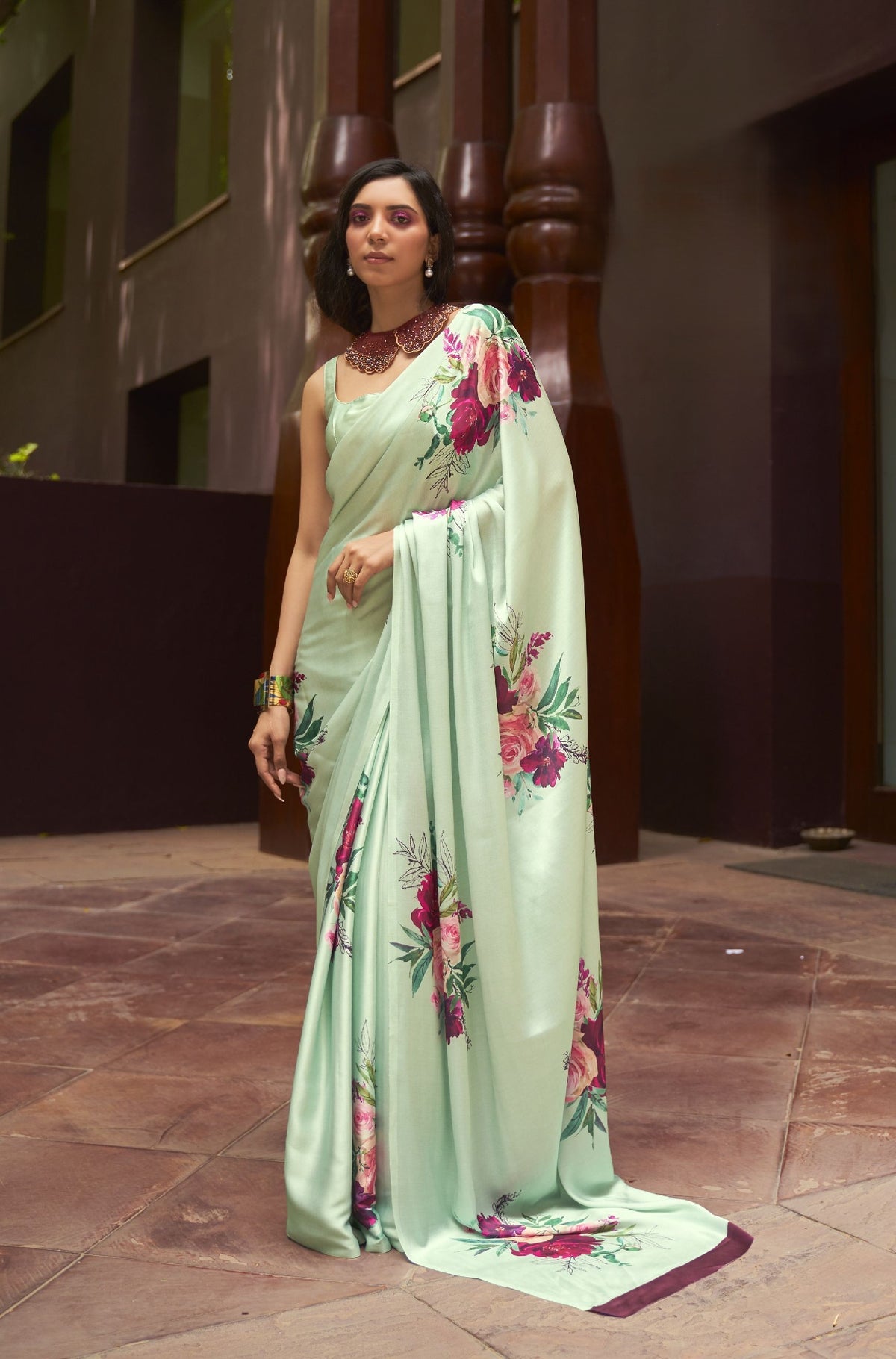Light green silk saree with oversized pink-red floral print—garden-inspired elegance for mehendi and festive gatherings