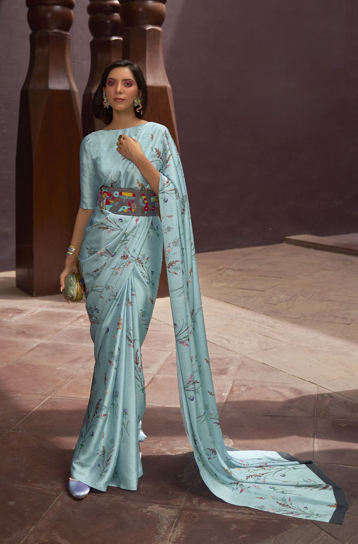 Blue floral silk saree with geometric belt—bold festive fusion for Navratri nights and cocktail soirees
