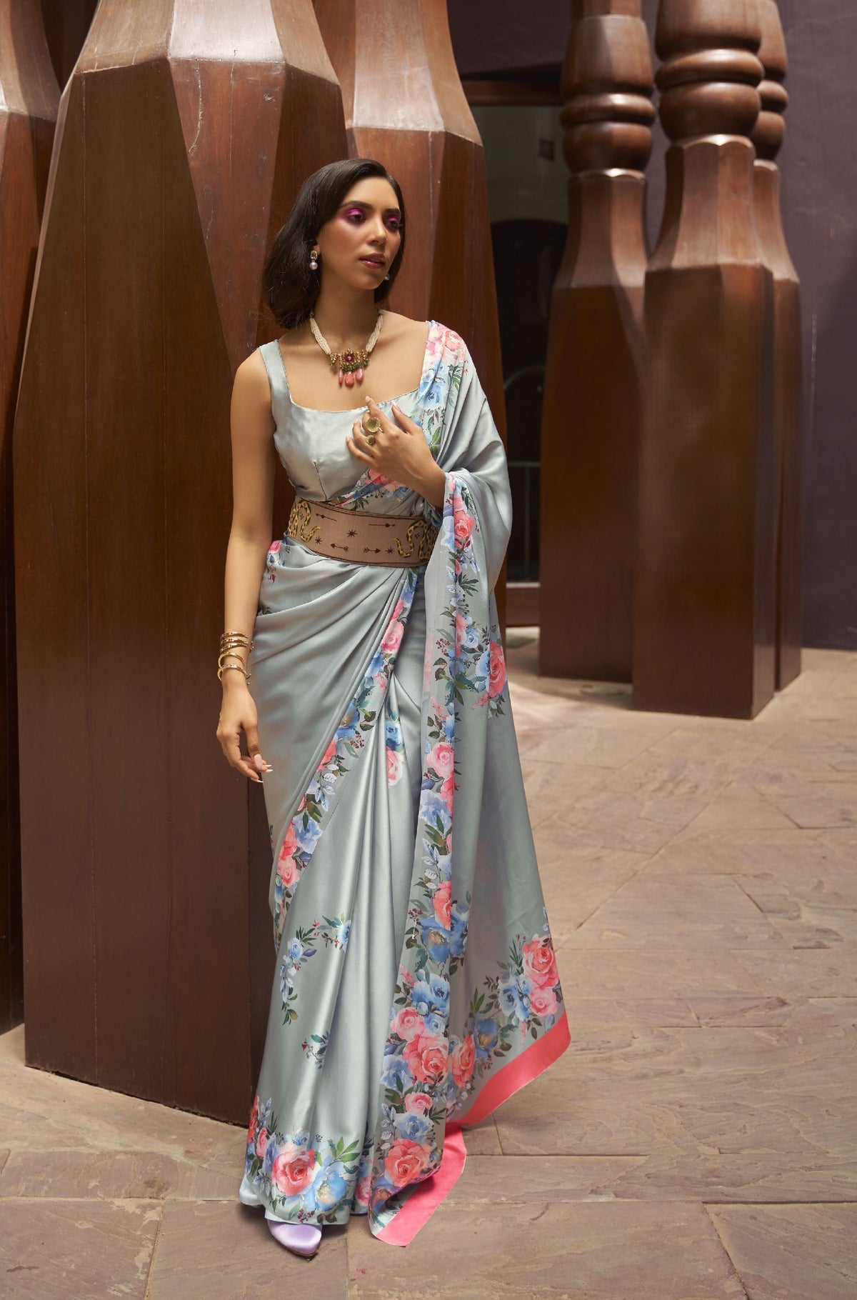 Light blue grey silk saree with pink rose print and pink border—romantic festive wear for Diwali and engagement looks