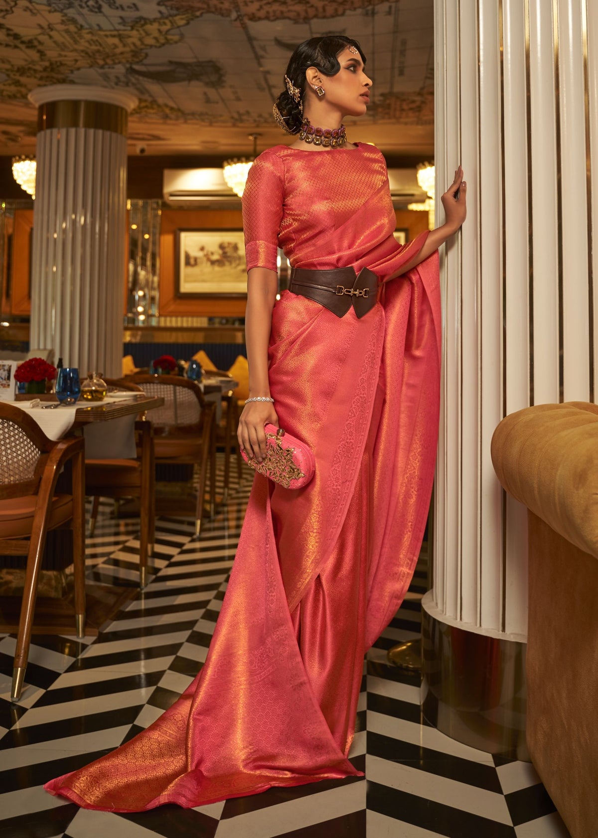 Pink nylon satin copper‑zari saree with a luminous finish and detailed zari patterns.