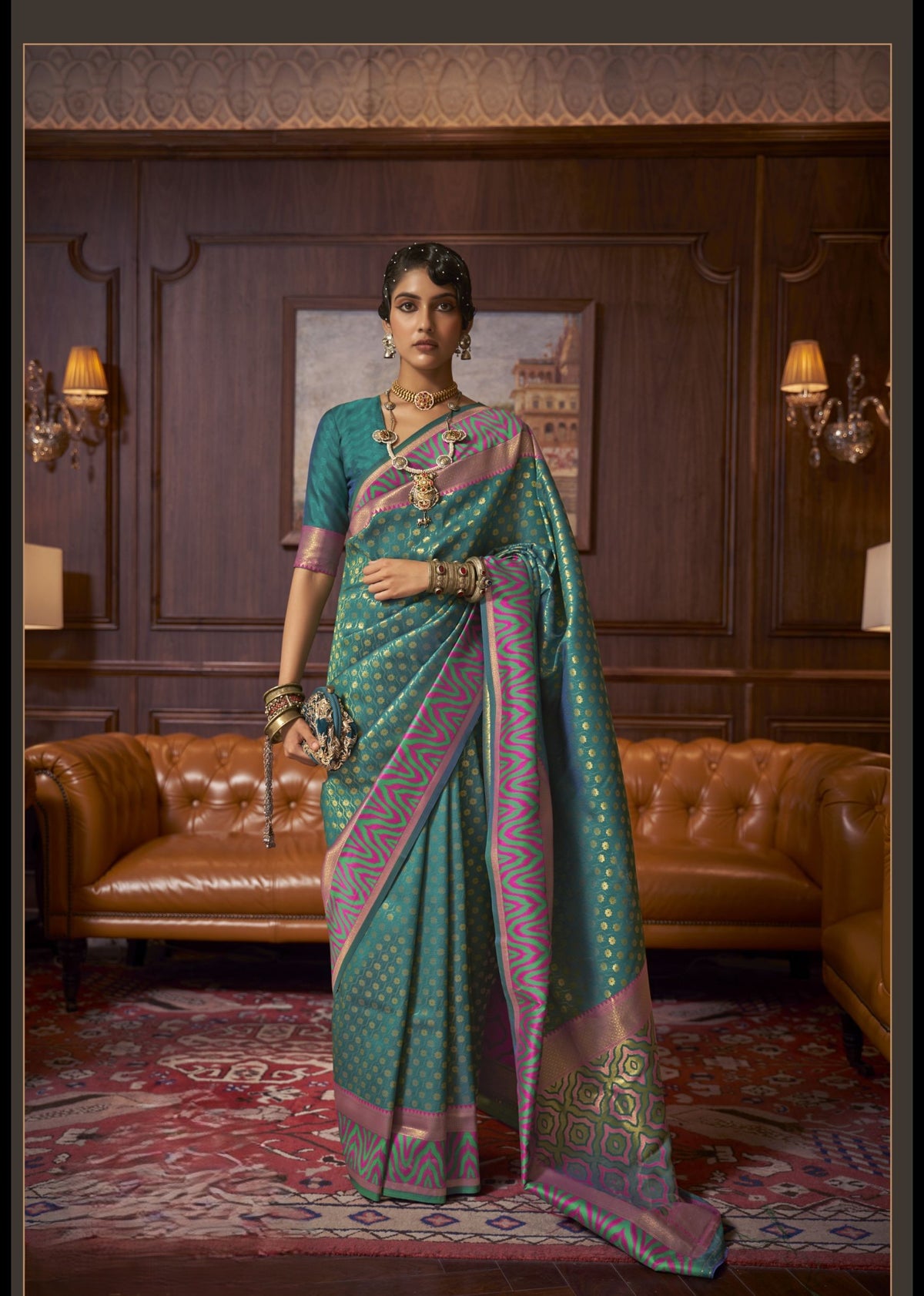 Teal Kazah Silk saree with gold polka dots and contrasting pink–green designer border, glossy silk drape, ideal for festive and party wear.