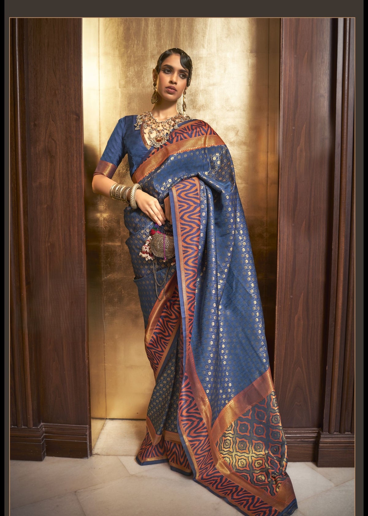 Royal blue Kazah Silk saree with intricate gold motifs and copper‑red designer border, rich silk texture, perfect for weddings and traditional events