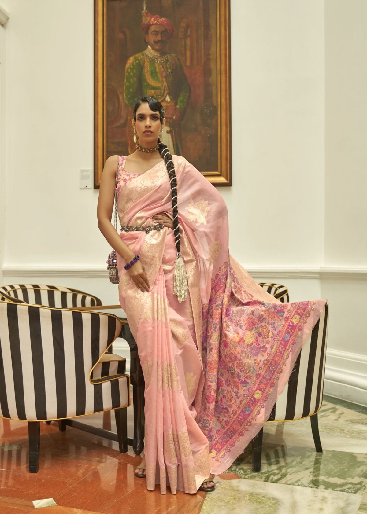 Pink silk saree with intricate floral embroidery and a structured modern waist belt.