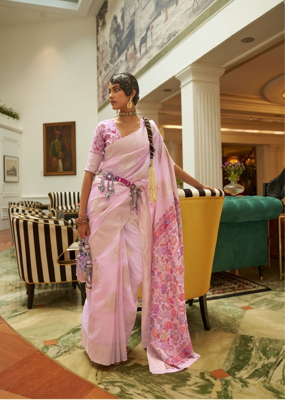 Pink and lavender silk saree with floral embroidery and a metallic designer waist belt.