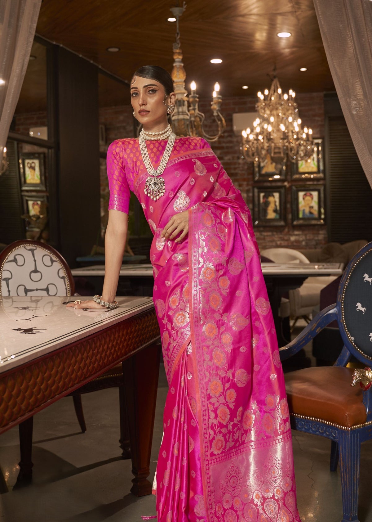 Hot pink silk saree with intricate golden floral and paisley motifs