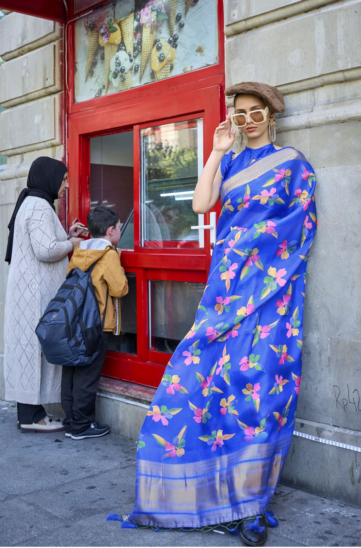 Blue floral satin organza saree with golden border—lightweight, breezy, ideal for street-style edits