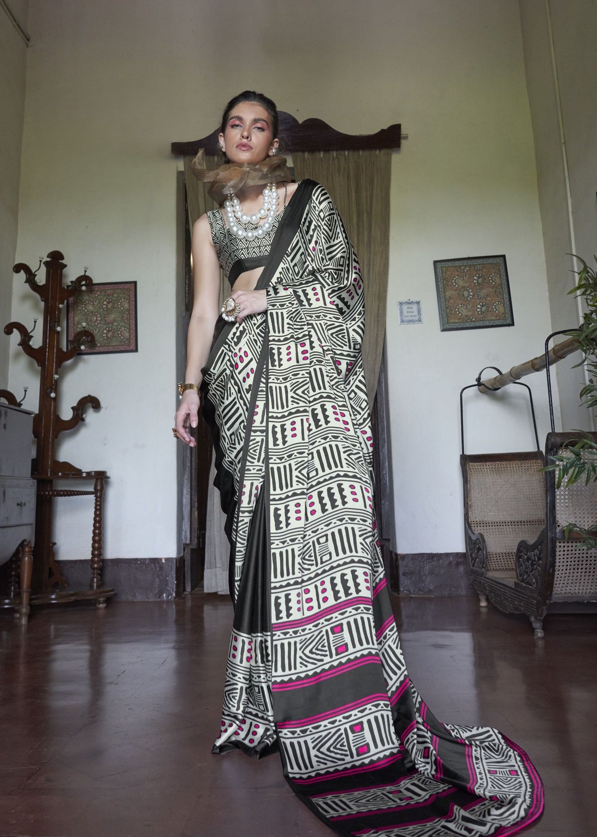 Woman wearing a traditional saree in an indoor setting, satin saree , Kaalin satin saree - front view