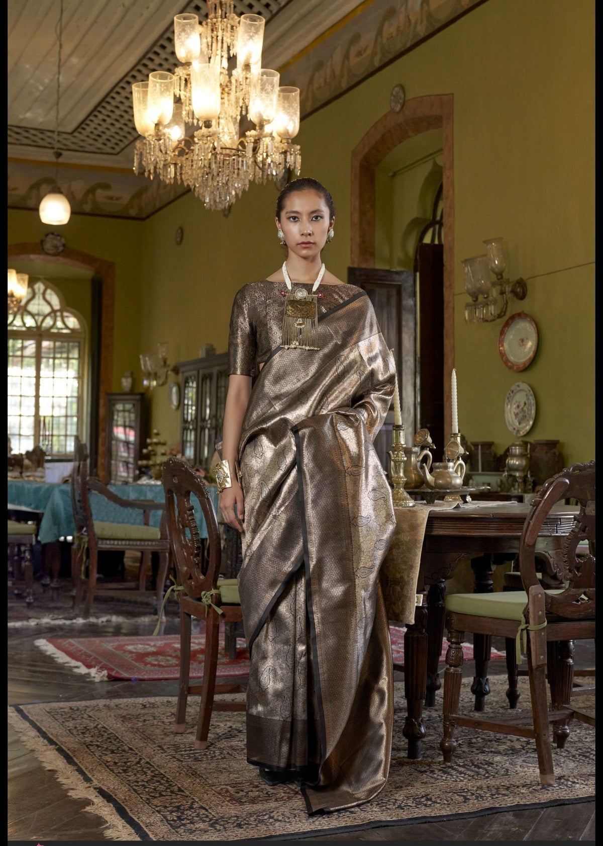 Metallic gold‑brown Kanjivaram silk saree with intricate woven patterns and a premium designer zari border.
