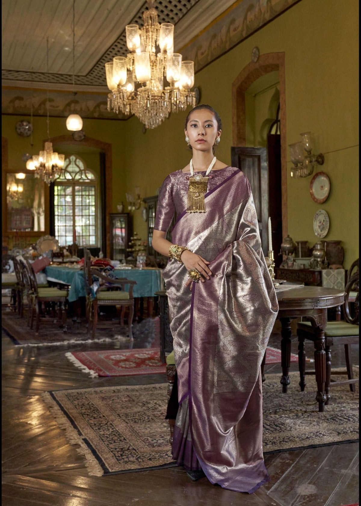 Purple Kanjivaram silk saree with silver zari detailing and a bold traditional border for a regal finish.